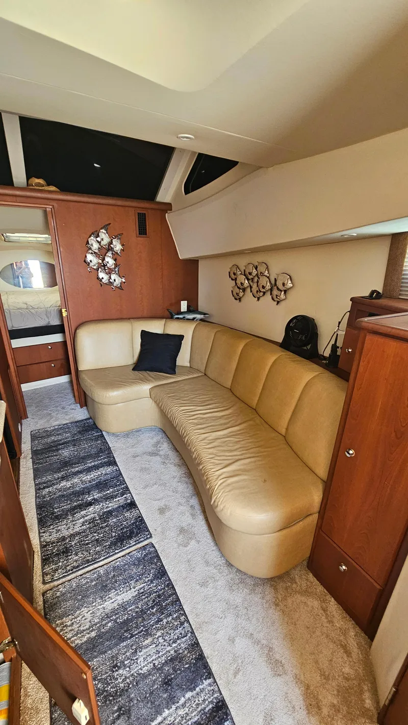 Slide: The Image of Interior of 2005 Silverton 330 Sport Bridge with beige leather seating and modern decor. - 5