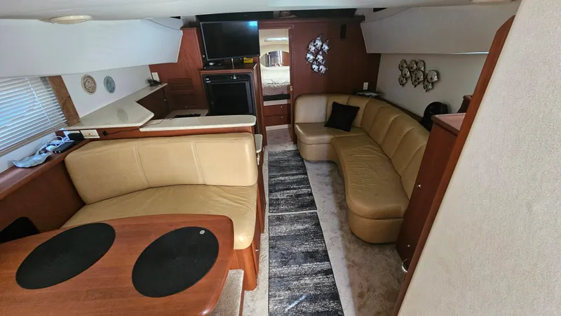 Slide: The Image of Interior of 2005 Silverton 330 Sport Bridge with beige seating and modern decor. - 6