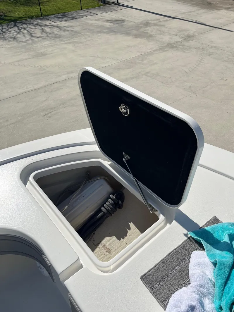Slide: The Image of Open storage compartment on 2021 Tideline 365 boat deck. - 12