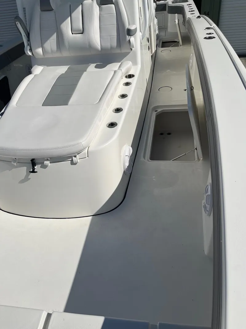 Slide: The Image of 2021 Tideline 365 boat interior with white seating and storage compartments. - 14