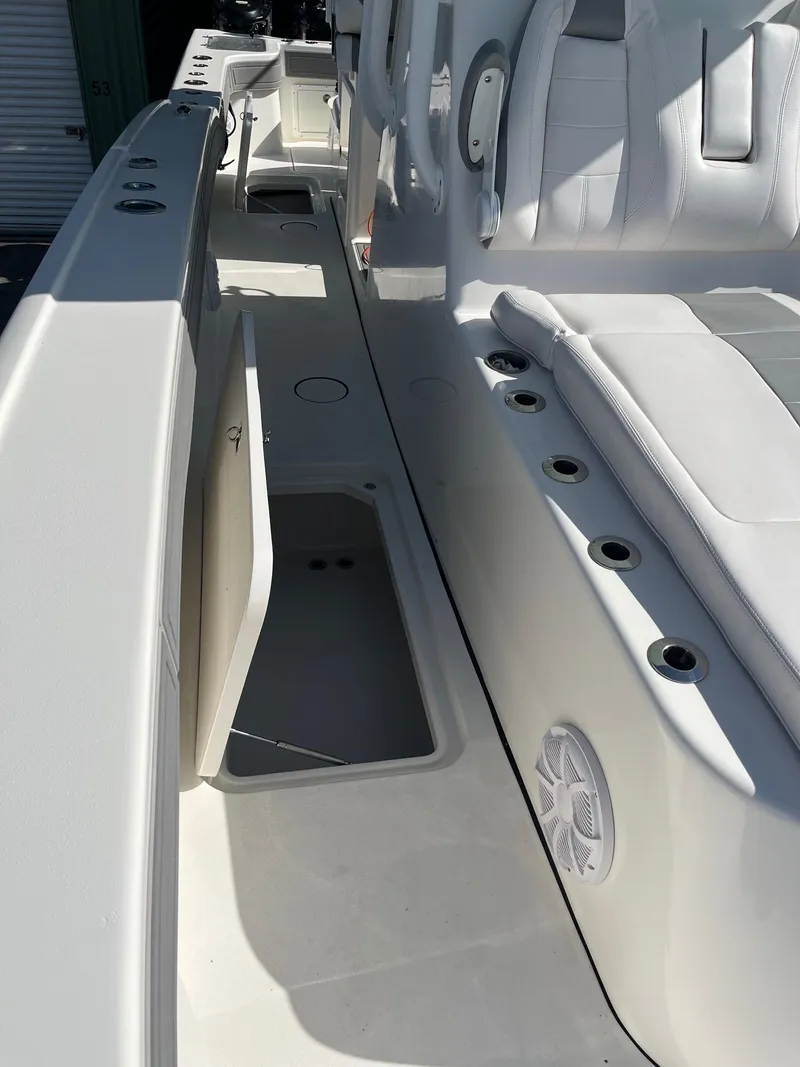 Slide: The Image of 2021 Tideline 365 boat interior with storage compartment and seating. - 16