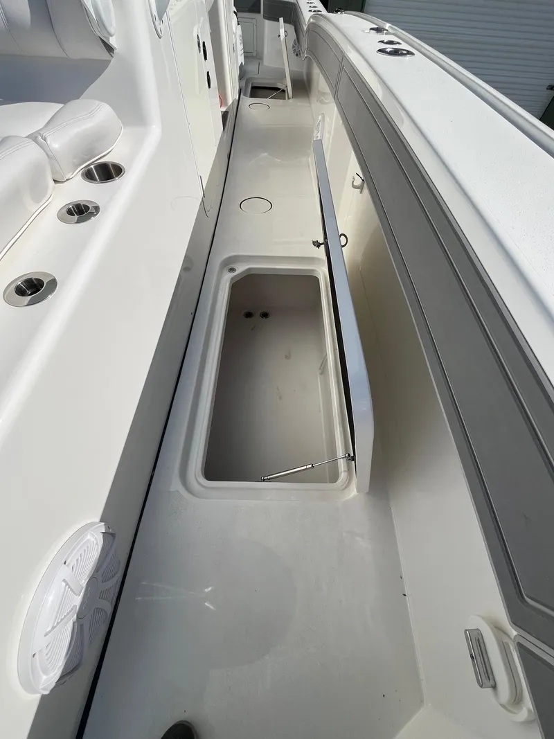Slide: The Image of 2021 Tideline 365 boat deck with open storage compartment. - 18