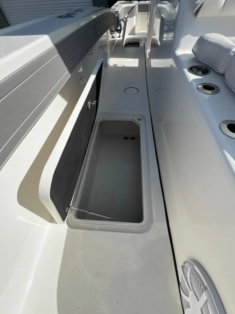 Slide: The Image of 2021 Tideline 365 boat interior with open storage compartment and seating area. - 19