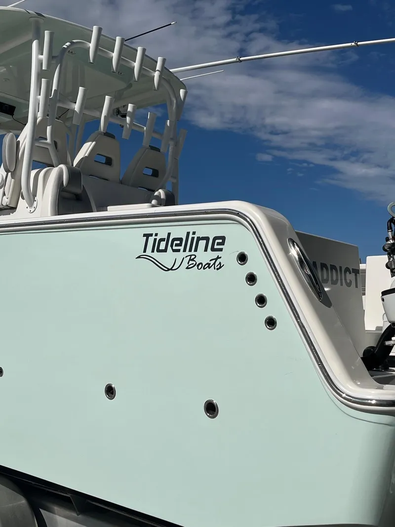 Slide: The Image of Tideline 365 boat, 2021 model, with sleek design under a clear blue sky. - 2