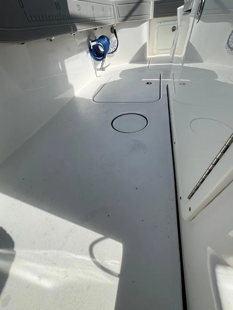 Slide: The Image of Interior view of a 2021 Tideline 365 boat, featuring a clean, white deck. - 20
