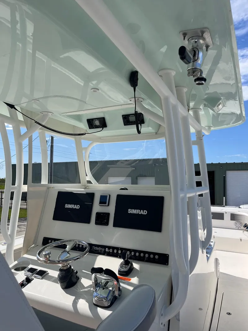 Slide: The Image of 2021 Tideline 365 boat console with Simrad electronics and steering wheel. - 28