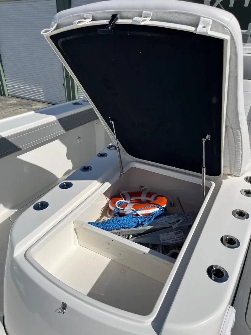 Slide: The Image of Open storage compartment on 2021 Tideline 365 boat with life jacket and ropes. - 29