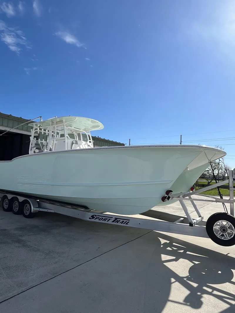 Slide: The Image of 2021 Tideline 365 boat on trailer under clear blue sky. - 32