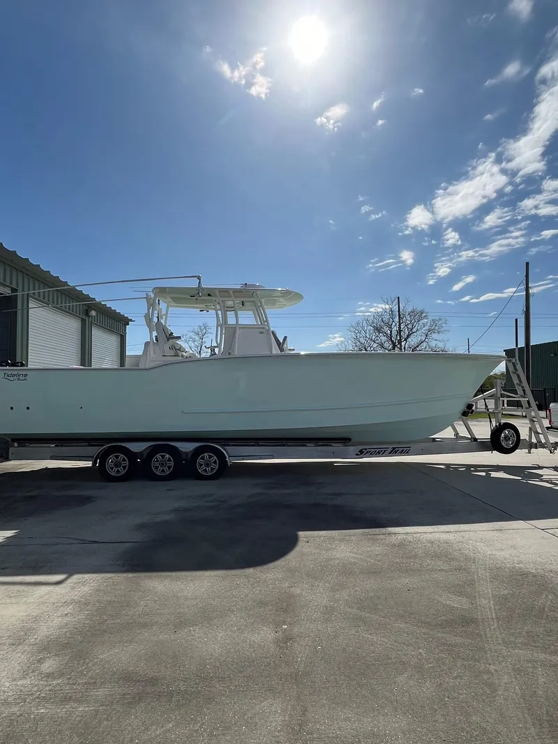 Slide: The Image of 2021 Tideline 365 boat on trailer under sunny sky. - 33