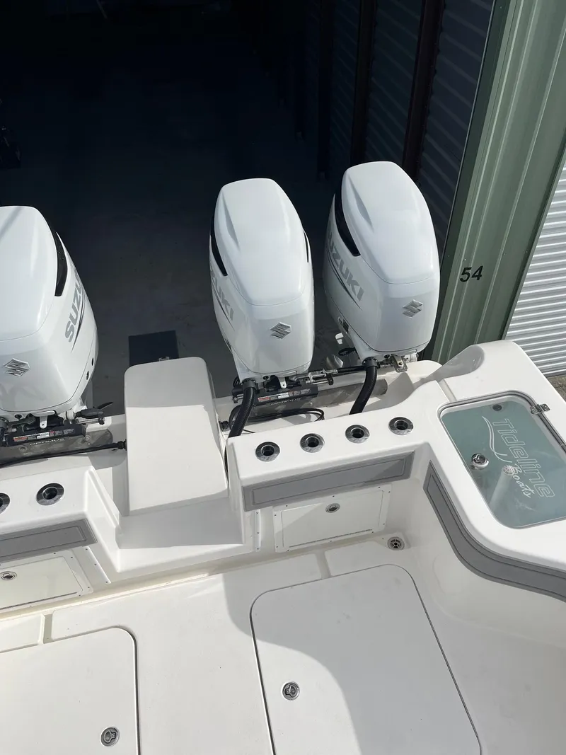 Slide: The Image of 2021 Tideline 365 boat with dual outboard motors in storage. - 35