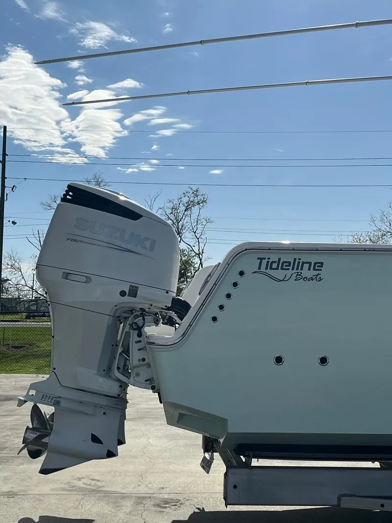 Slide: The Image of 2021 Tideline 365 boat with outboard motor under clear blue sky. - 37
