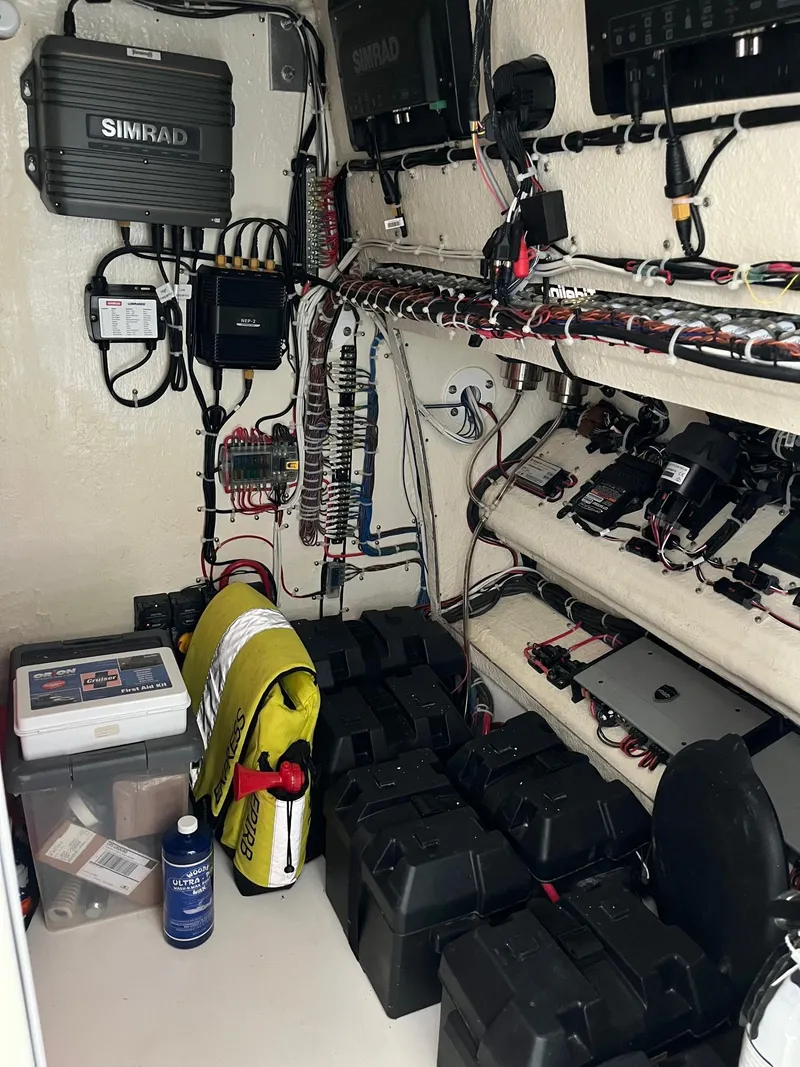 Slide: The Image of Electrical equipment setup in a 2021 Tideline 365 boat, featuring Simrad systems and organized wiring. - 39