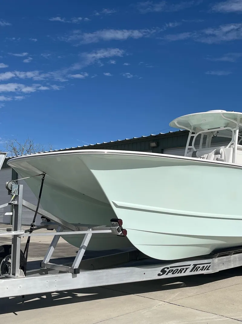 Slide: The Image of 2021 Tideline 365 boat on trailer under clear blue sky. - 4
