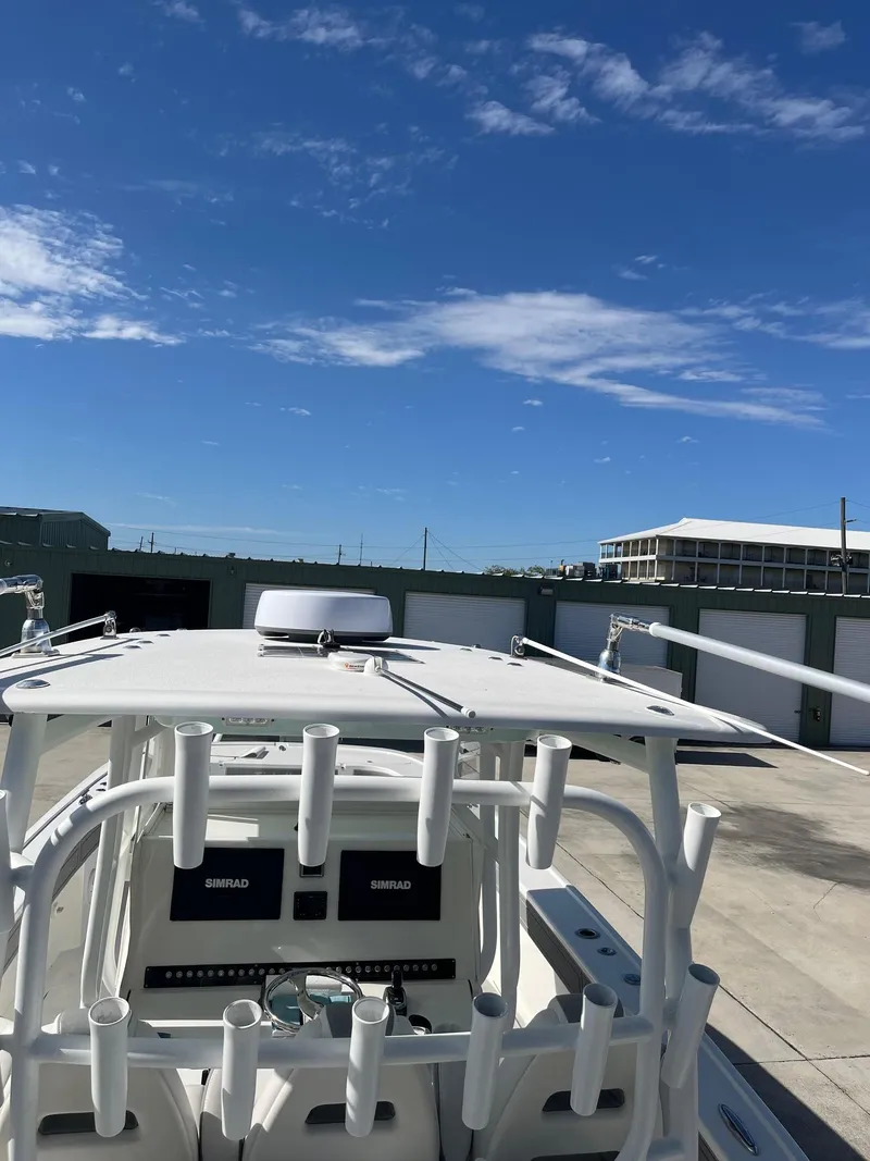 Slide: The Image of 2021 Tideline 365 boat with rod holders under a clear blue sky. - 43