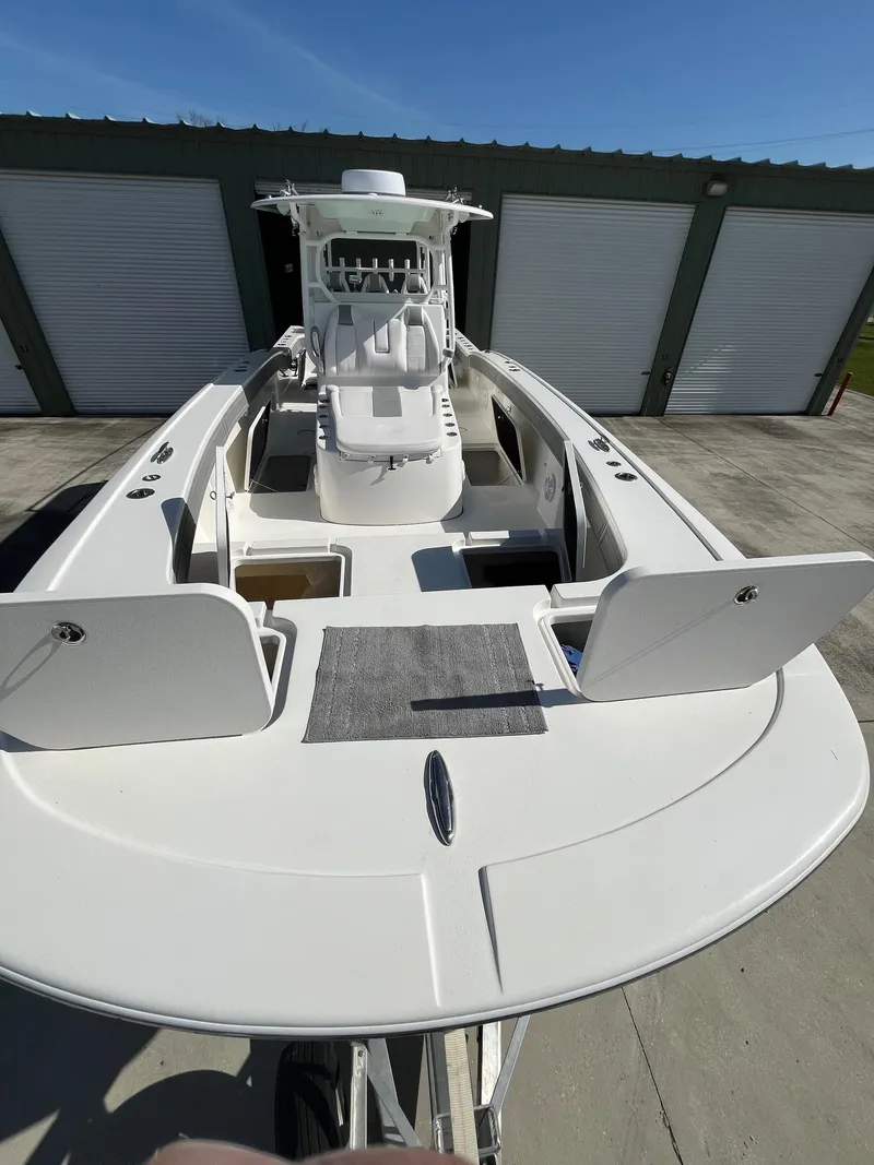 Slide: The Image of 2021 Tideline 365 boat with open deck, docked near storage units. - 5