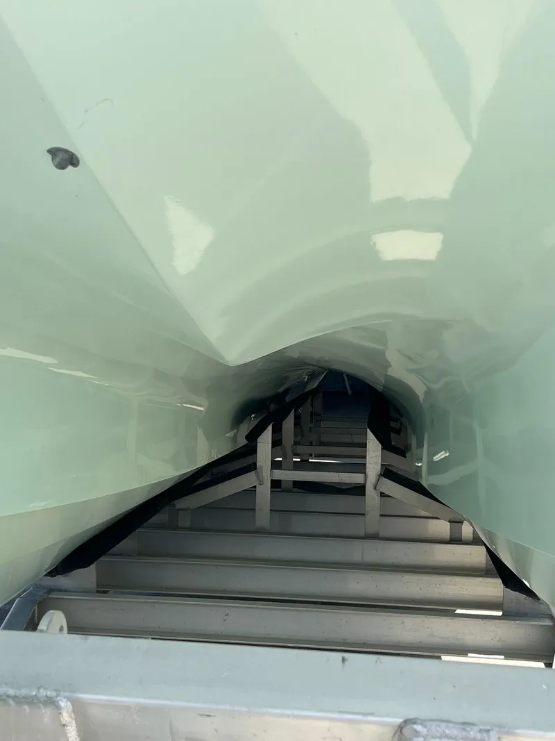 Slide: The Image of View of Tideline 365 boat hull, 2021 model, on a metal trailer. - 6