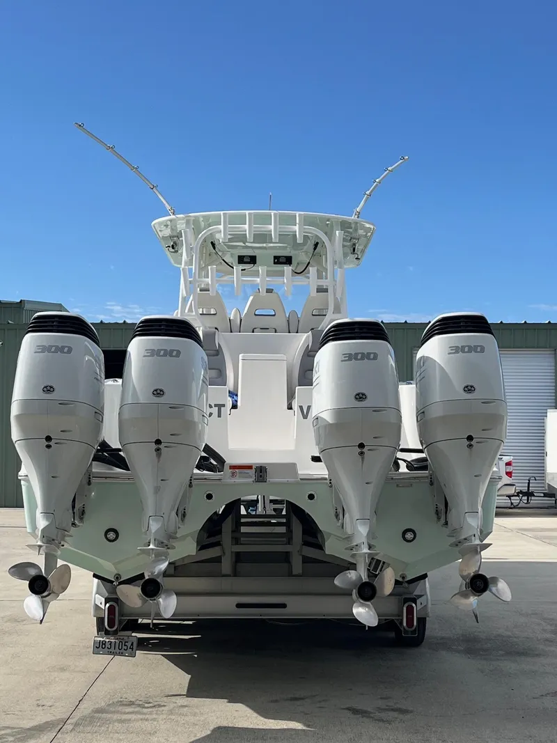 Slide: The Image of 2021 Tideline 365 boat with four powerful outboard engines, docked under clear blue sky. - 7