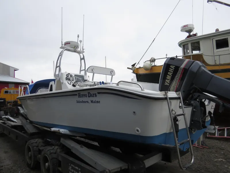 The Image of Edgewater 247CC boat from 2000 on trailer, featuring Yamaha outboard motor. - 0