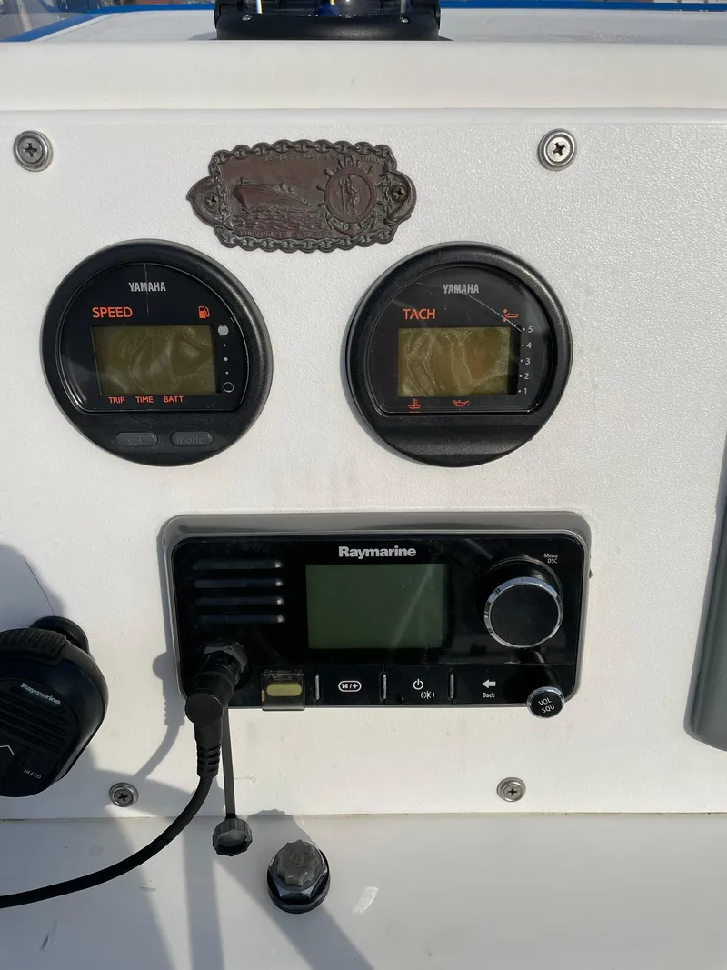 Slide: The Image of Edgewater 247CC 2000 dashboard with Yamaha gauges and Raymarine radio. - 10