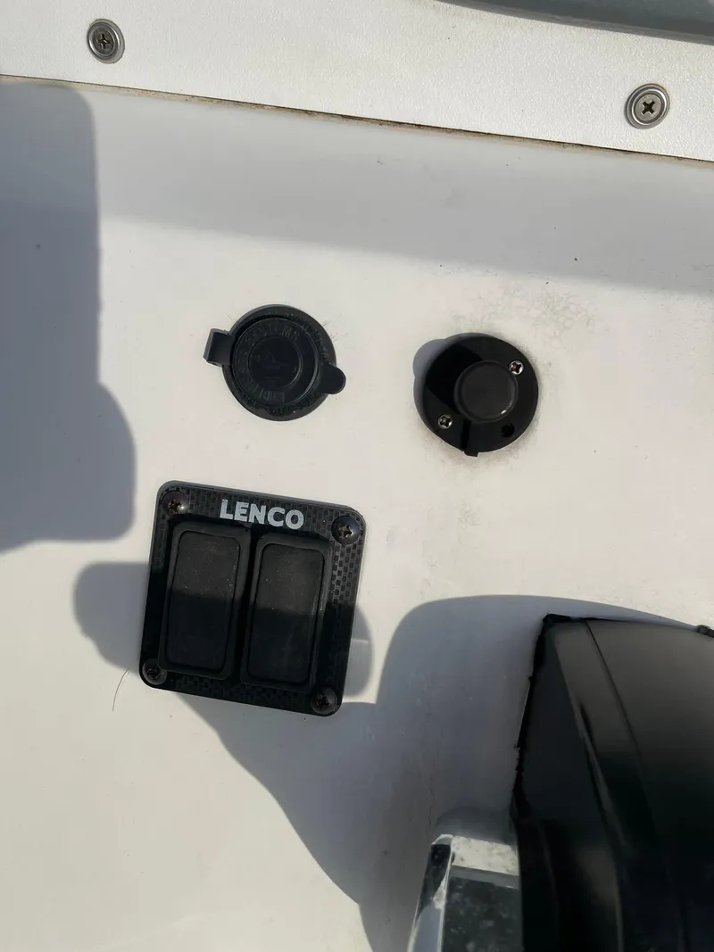 Slide: The Image of Edgewater 247CC 2000 boat controls with Lenco switches and dials. - 13