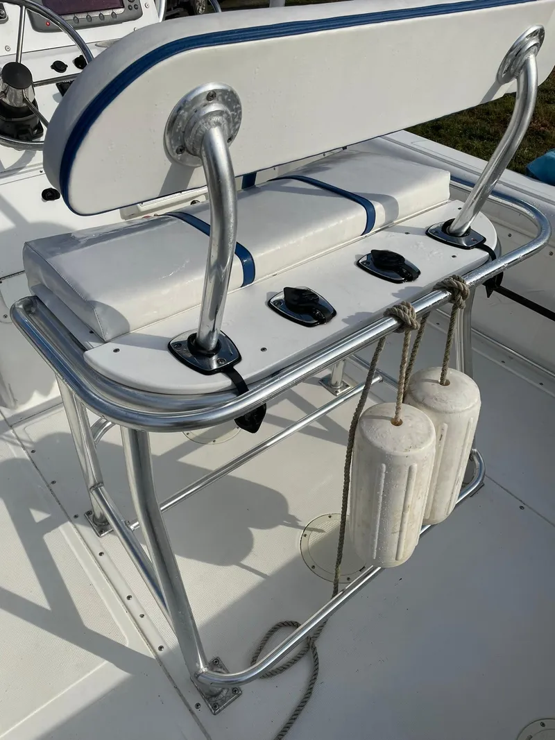 Slide: The Image of Edgewater 247CC 2000 boat seat with rod holders and fenders attached. - 19