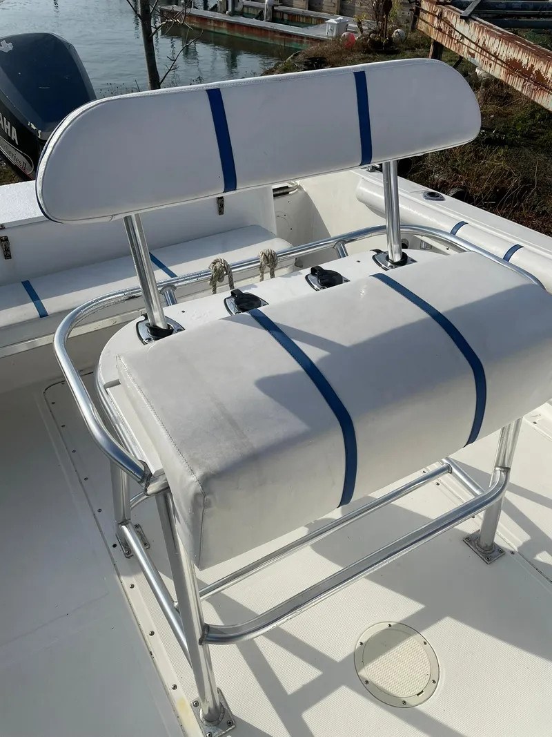 Slide: The Image of Edgewater 247CC 2000 boat seat with blue-striped upholstery and metal frame. - 20