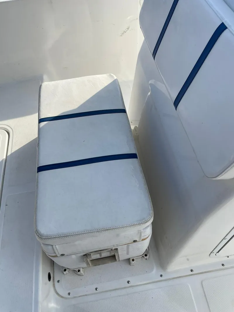 Slide: The Image of Edgewater 247CC 2000 boat seating with blue-striped cushions. - 22