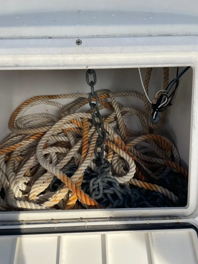 Slide: The Image of Rope and chain storage in 2000 Edgewater 247CC boat compartment. - 26