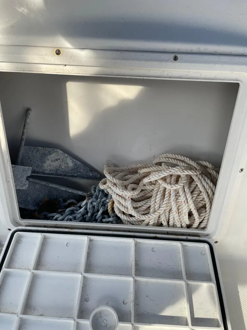Slide: The Image of Anchor and rope storage in 2000 Edgewater 247CC boat compartment. - 27