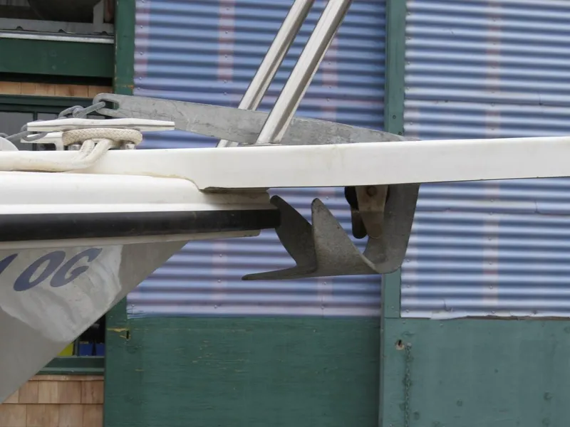 Slide: The Image of Edgewater 247CC 2000 boat anchor and bow detail against corrugated metal background. - 29