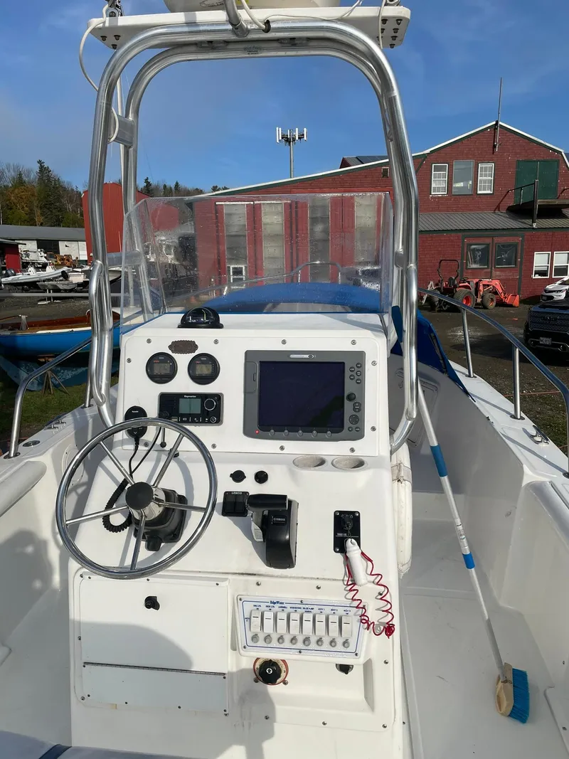 Slide: The Image of Edgewater 247CC 2000 boat console with steering wheel and navigation equipment. - 3