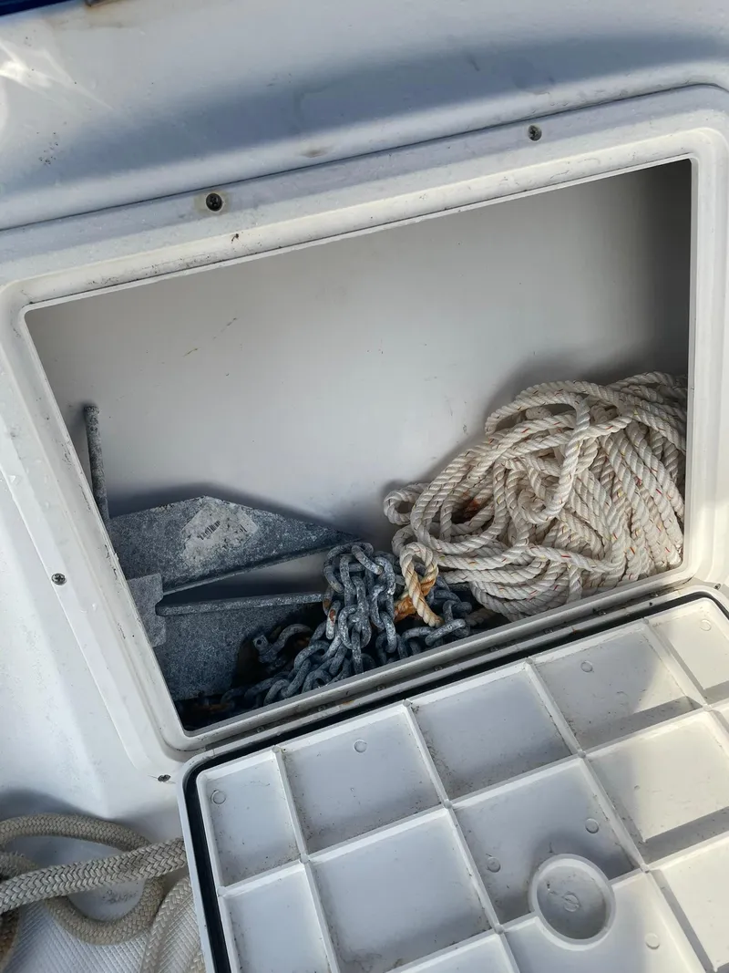 Slide: The Image of Boat storage compartment with anchor, chain, and rope on Edgewater 247CC, 2000 model. - 32