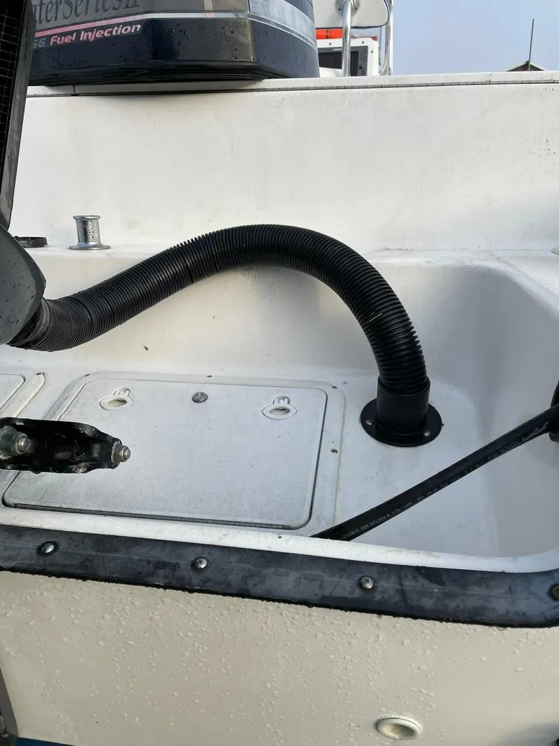 Slide: The Image of Edgewater 247CC boat, 2000 model, featuring a fuel injection system and hose connection. - 34