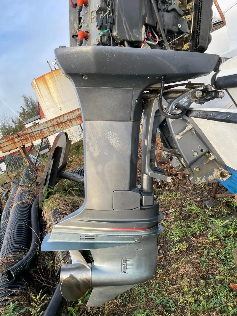 Slide: The Image of Outboard motor of a 2000 Edgewater 247CC boat, displayed outdoors. - 37