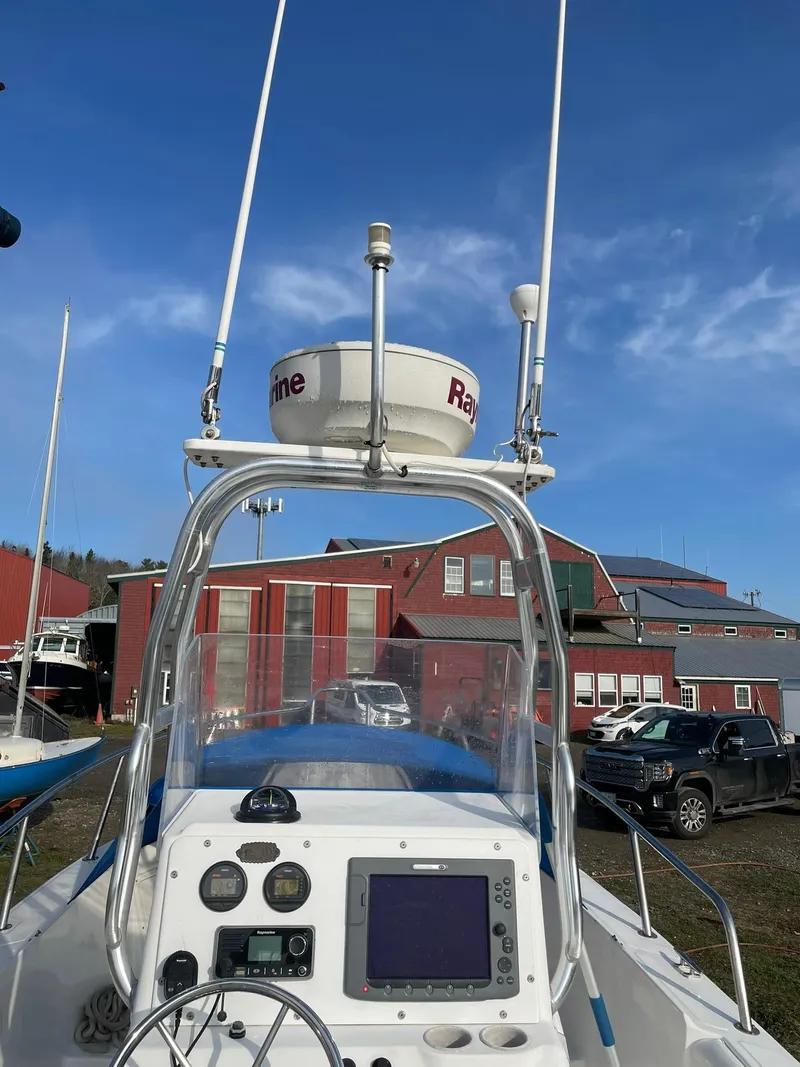 Slide: The Image of Edgewater 247CC 2000 boat console with radar and navigation equipment under clear blue sky. - 4