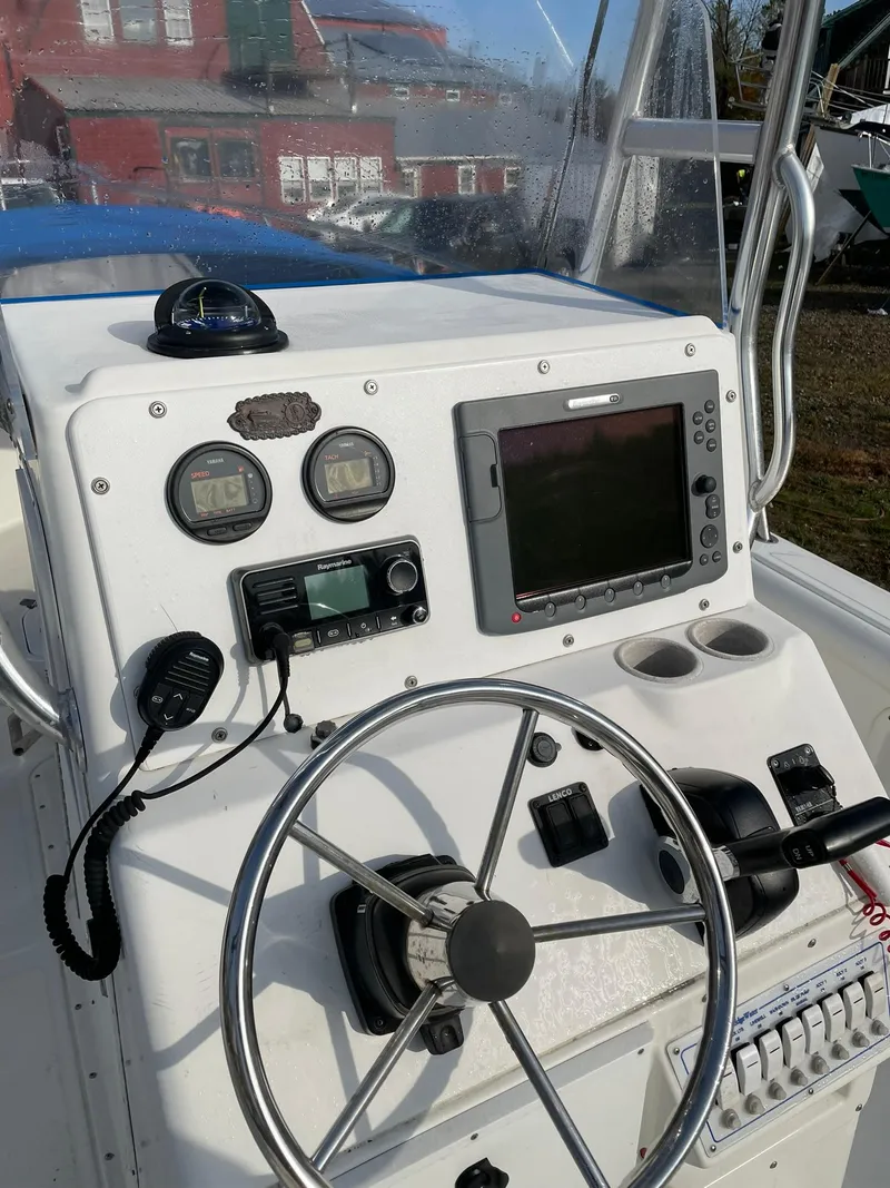 Slide: The Image of Edgewater 247CC 2000 boat console with steering wheel and navigation equipment. - 6