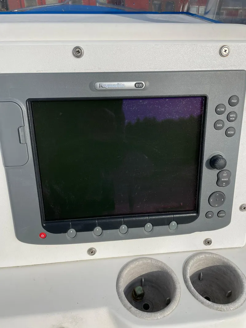 Slide: The Image of Edgewater 247CC 2000 boat console with Raymarine display and cup holders. - 7