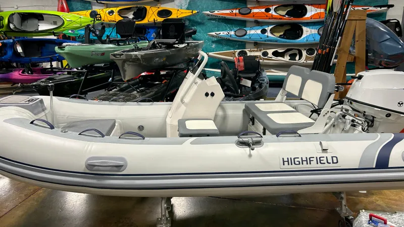 Slide: The Image of 2026 Highfield Classic 360 GT inflatable boat on trailer, parked outdoors. - 7