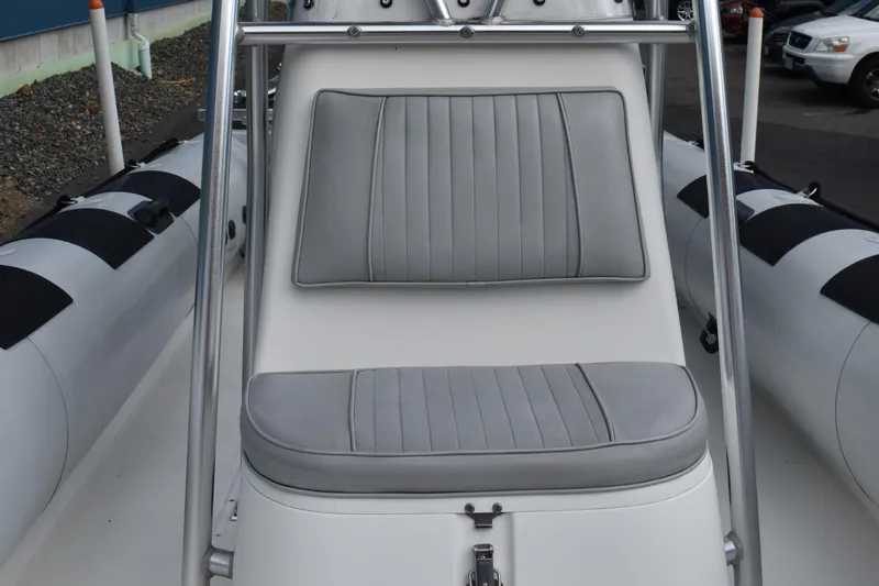 Slide: The Image of 2015 Ribcraft 7.8 inflatable boat, docked, with spacious seating and sturdy railings. - 5