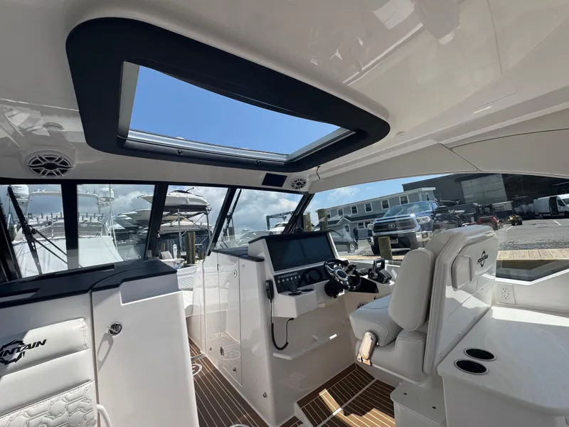 Slide: The Image of Interior of 2025 Fountain 39 DX boat with modern helm and seating. - 14
