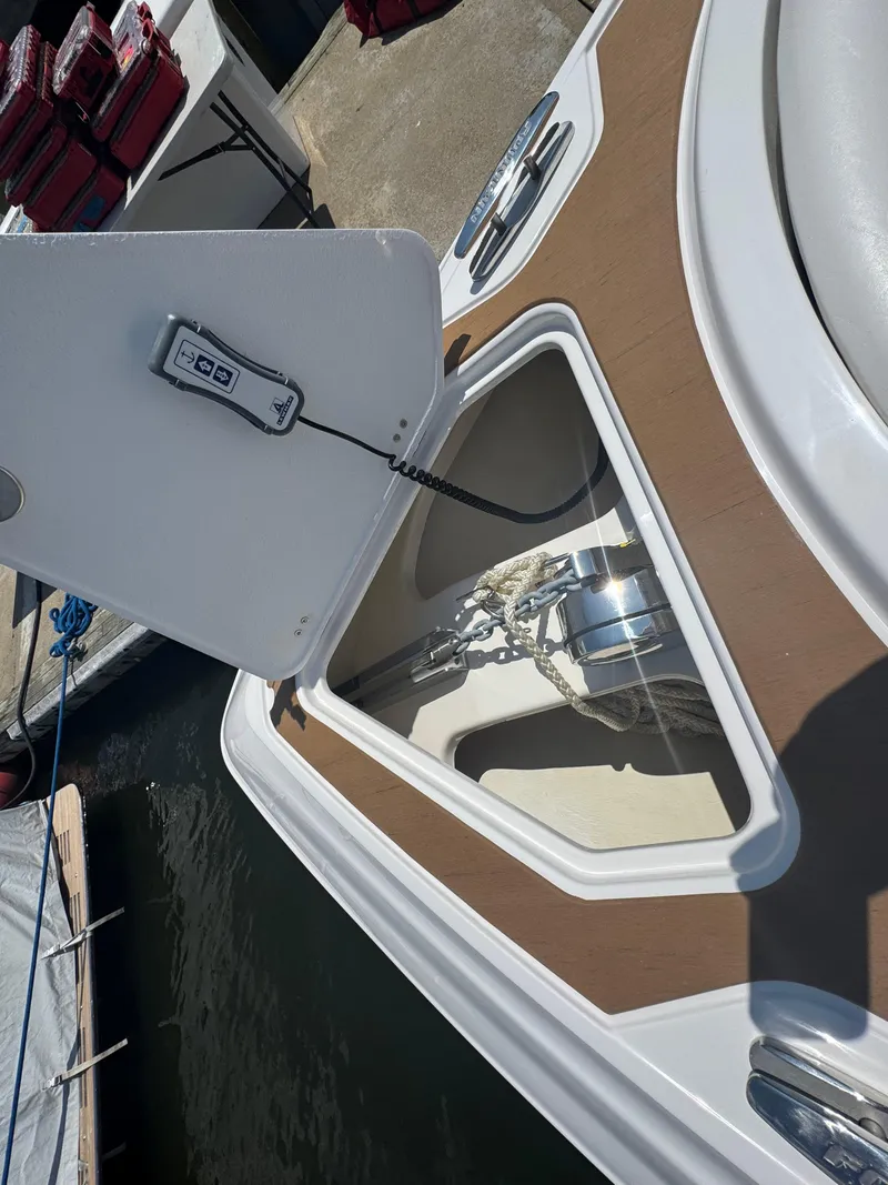 Slide: The Image of 2025 Fountain 39 DX boat anchor compartment with control panel, docked at marina. - 18