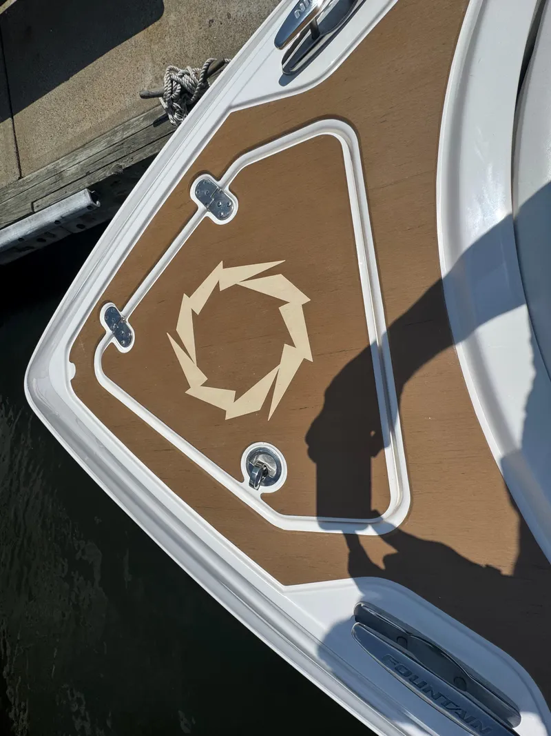Slide: The Image of 2025 Fountain 39 DX boat deck with geometric design and cleats, docked by water. - 19