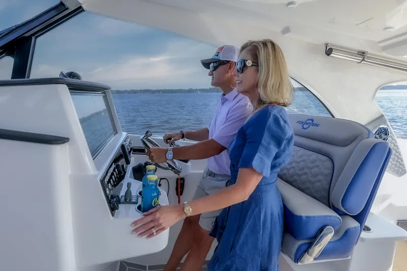Slide: The Image of Couple enjoying a ride on a 2025 Fountain 39 DX boat. - 2