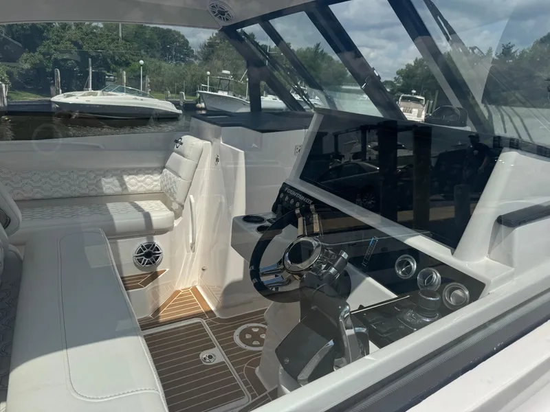 Slide: The Image of Interior view of 2025 Fountain 39 DX boat with modern controls and seating. - 23