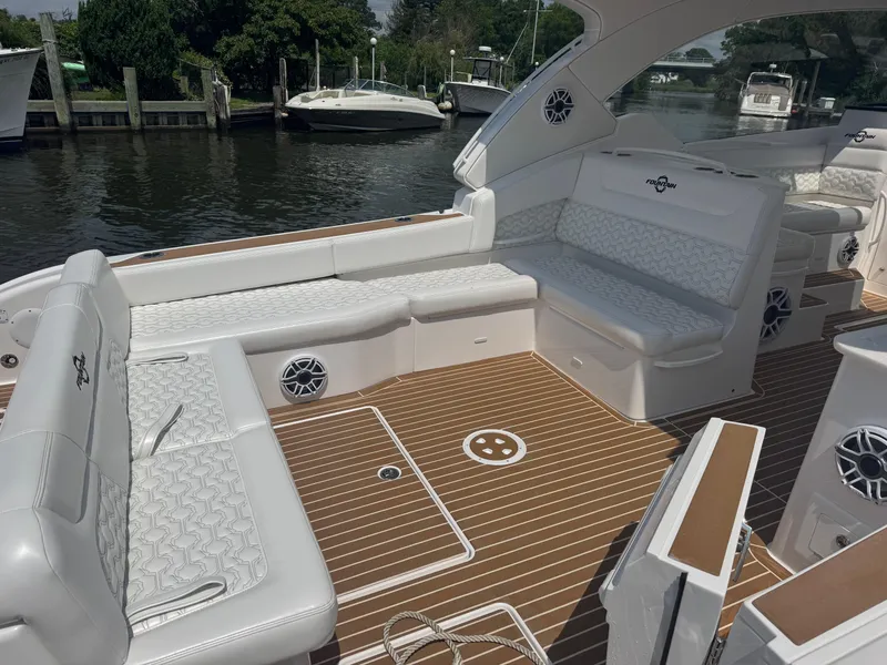 Slide: The Image of Interior of 2025 Fountain 39 DX boat with microwave and cushioned seating area. - 7