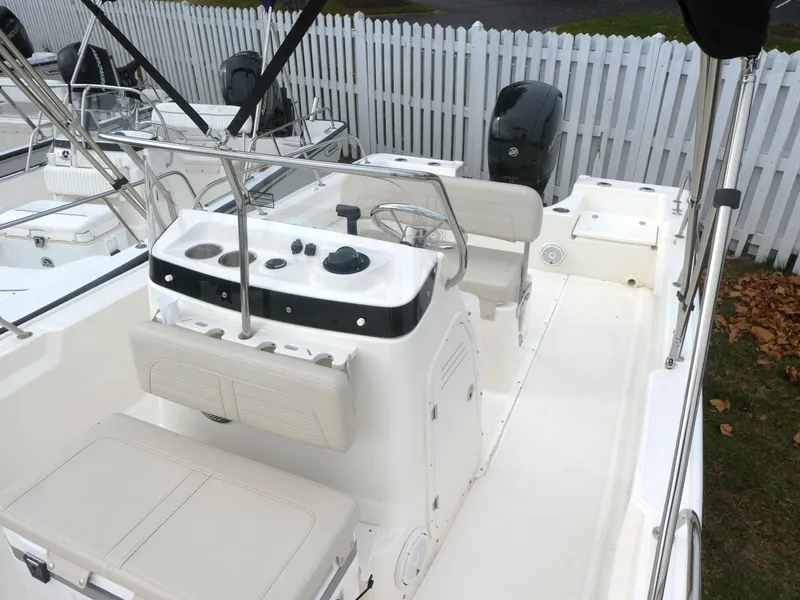 Slide: The Image of 2024 Boston Whaler 190 Montauk boat interior with steering console and seating. - 10