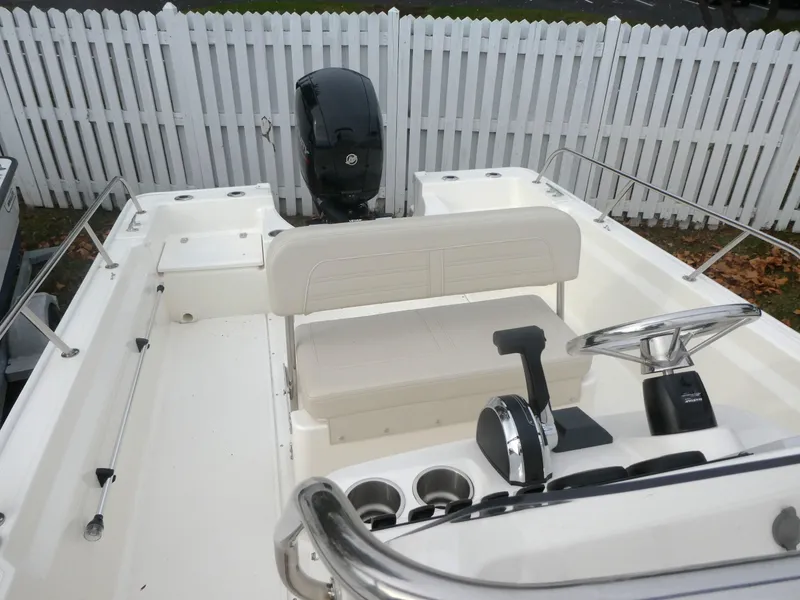 Slide: The Image of 2024 Boston Whaler 190 Montauk boat interior with steering console and seating. - 12