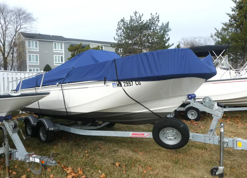 Slide: The Image of 2024 Boston Whaler 190 Montauk boat on trailer with blue cover. - 3