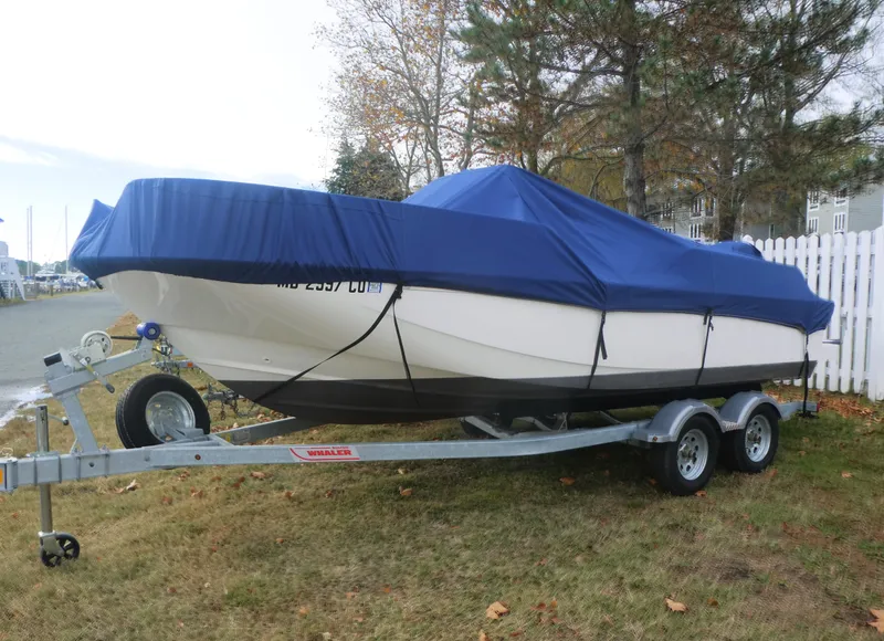 Slide: The Image of 2024 Boston Whaler 190 Montauk boat on trailer, covered with blue tarp. - 4