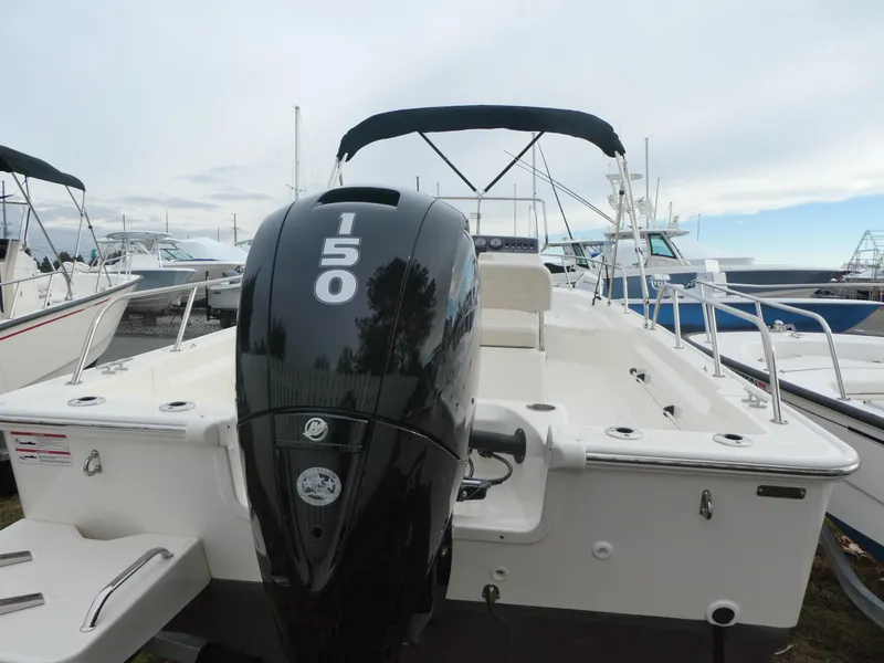 Slide: The Image of 2024 Boston Whaler 190 Montauk boat with 150 HP engine, docked at marina. - 5